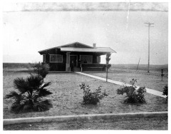 Van Nuys, CA - First house in Van Nuys subdivision, located at the intersection of Chandler and Van Nuys Boulevards - people are unidentified