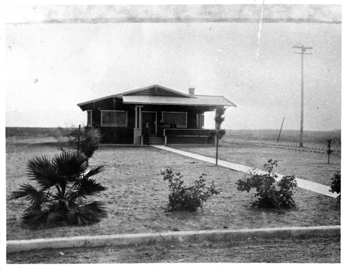 Van Nuys, CA - First house in Van Nuys subdivision, located at the intersection of Chandler and Van Nuys Boulevards - people are unidentified