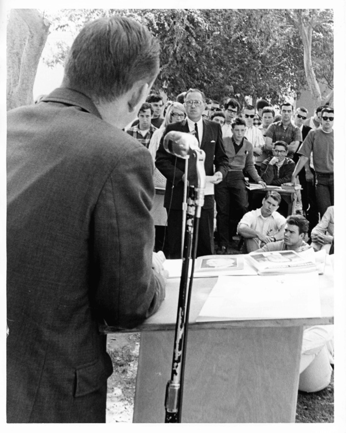 Van Nuys, CA - Los Angeles Valley College - John Rousselot, speaker (with back to camera) - John Buchanan (wearing glasses), sponsor of quadrangle has argument with Rousselot