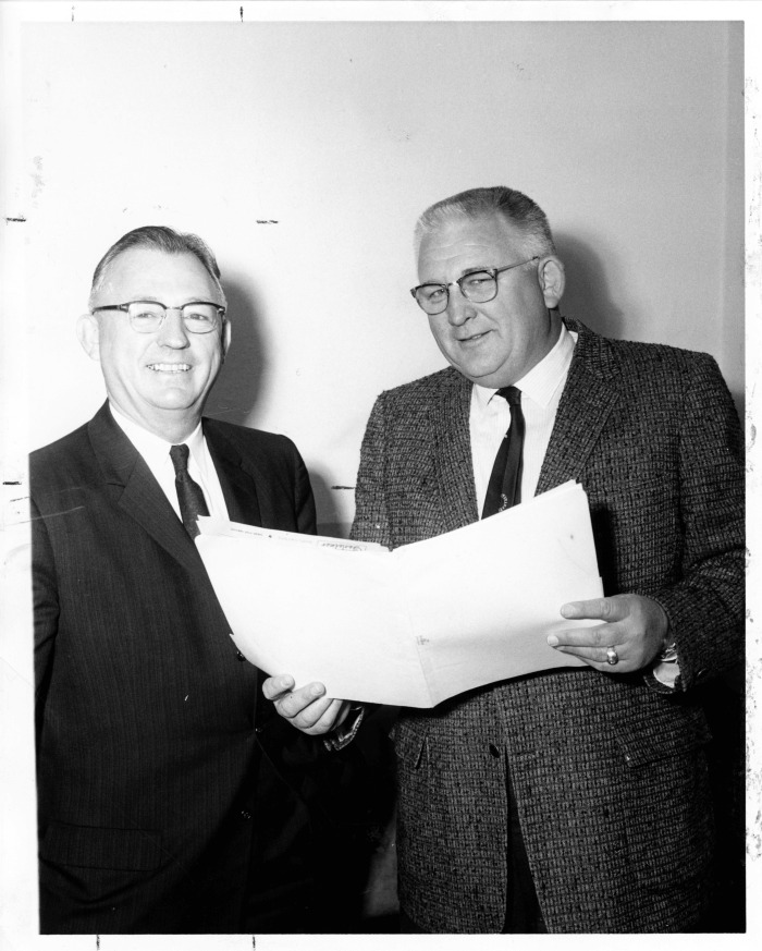 San Fernando, CA - Chamber of Commerce - Elvin Schmidt (right), retiring President of San Fernando Chamber of Commerce discusses plans with R.P. Loomis, who will be installed as President