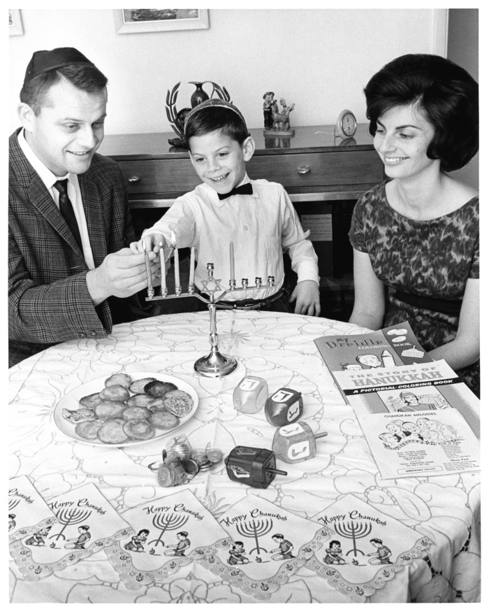 Hanukkah - Steven Shoham lights menorah. His parents are Rabbi and Mrs. Gilbert Shoham of Shaarey Zedek congregation