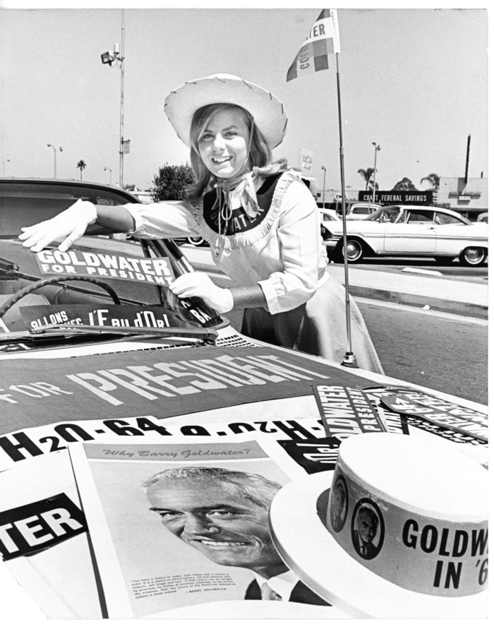Panorama City, CA - Goldwater campaign - Cherie Adams decorates a car outside Goldwater headquarters at 8551 Vesper Ave.