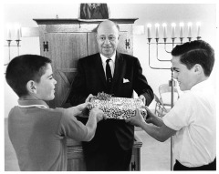 Temple Juda - Youths reach for present - Dr. Harris Hirschberg, temple rabbi, offers gifts to Steve Zimmerman (left) and Jay Jackter