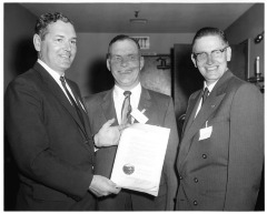 Northridge, CA - San Fernando Valley State College (CSUN) - Delmar Oviatt (center), Dean of Instruction is awarded for service. City Councilman Patrick McGee (left) and Albert Zoraster, new President of Valley Chamber of Commerce