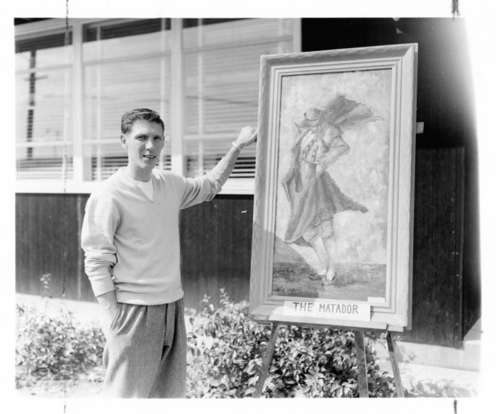 Northridge, CA - Valley State College (CSUN) - Frank St. Denis, student body president, shows picture of school's new nickname "Matadors." Red and while will be the colors