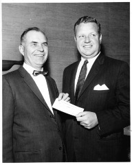 Northridge, CA - San Fernando Valley State College (CSUN) - Accepting check for Valley Youth Foundation are Dr. Delmar T. Oviatt (left) and Foundation President John Flanigan, Vice President of Anheuser Busch, Inc.